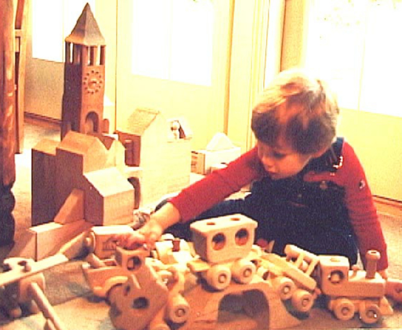 Child playing with handcrafted wooden toys